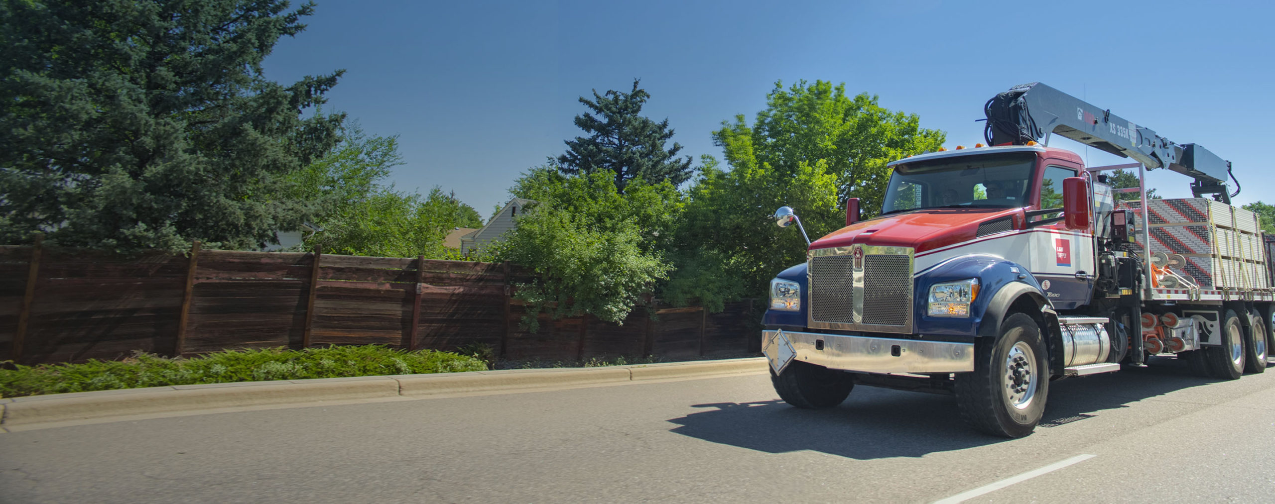 Red, White and Blue L&W Supply Truck on the Highway