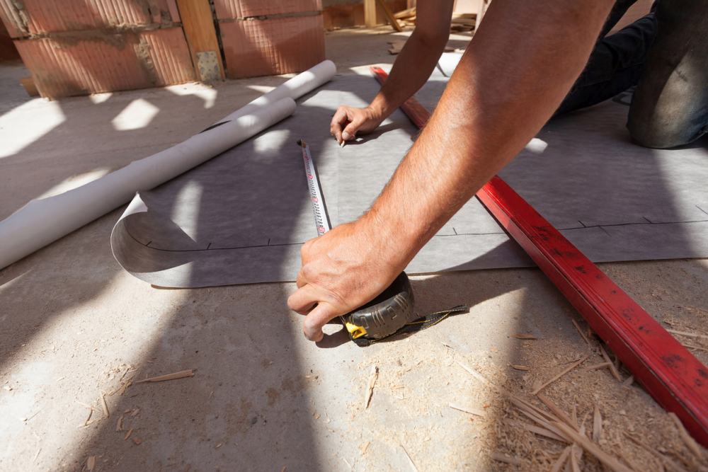 Worker prepare to cut the weather resistant barrierbarrier