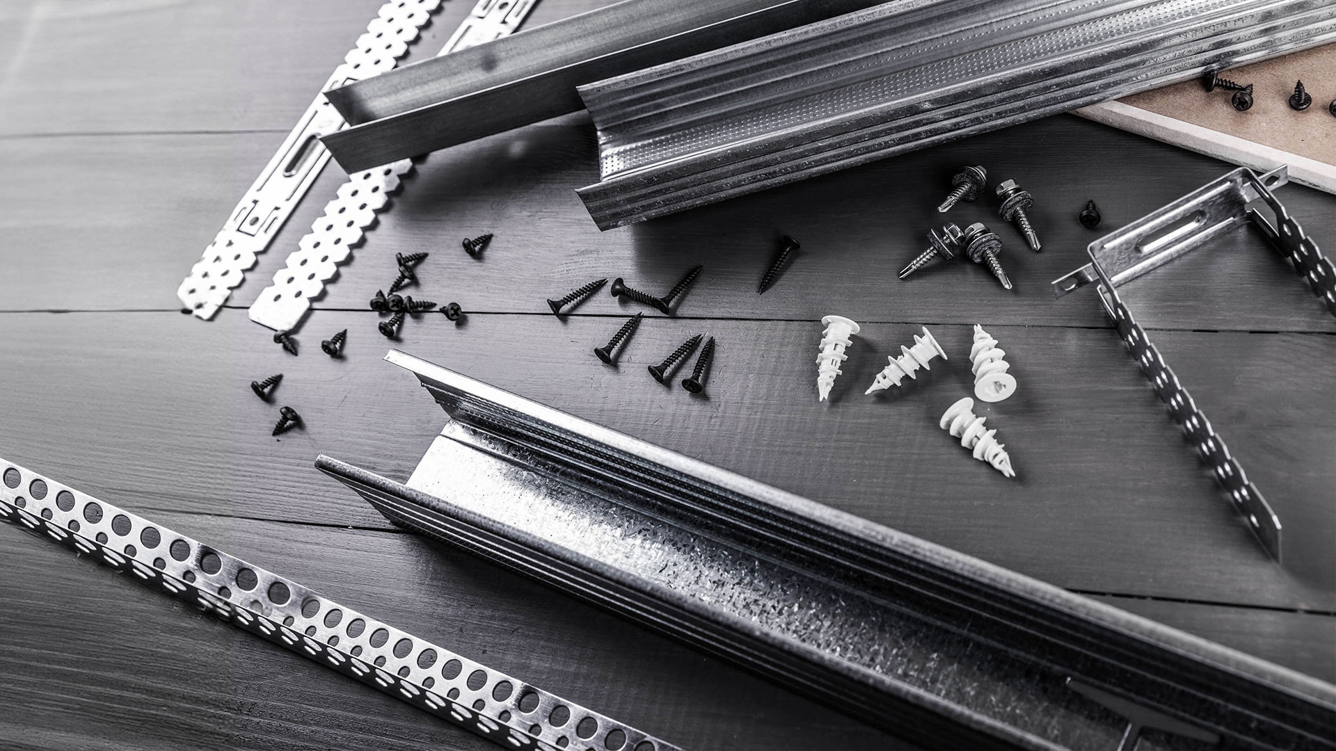 A variety of different fasteners scattered on a table.