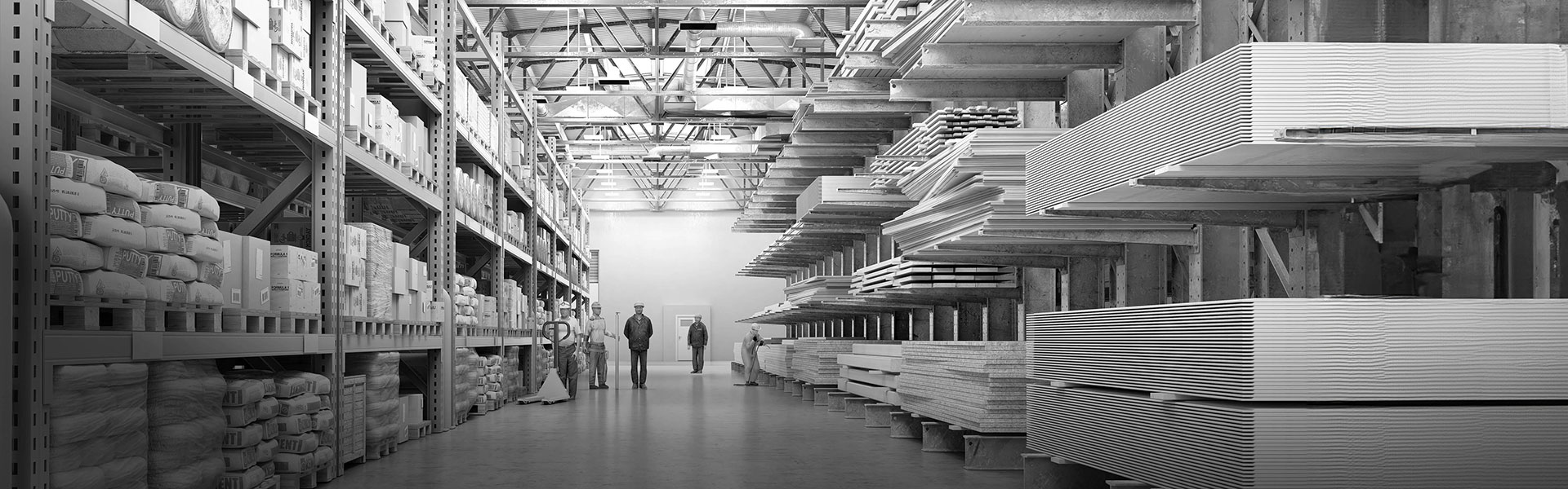 A warehouse with shelving units on the left and right showing a variety of building products.